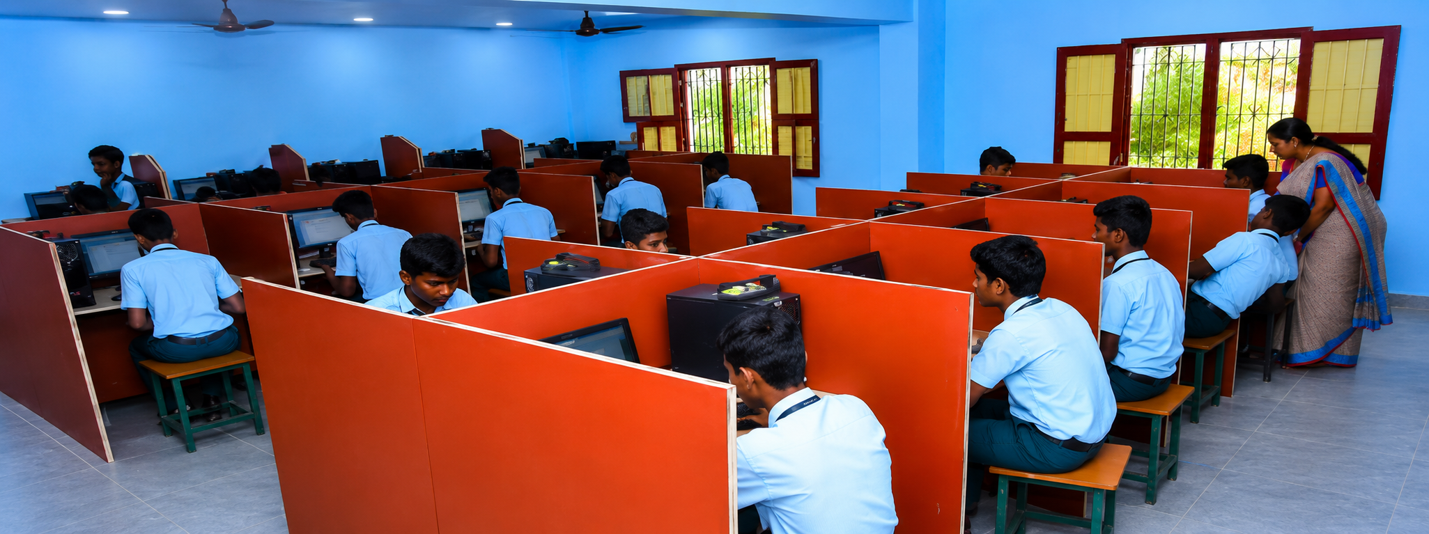 Students using computers inside the school computer laboratory